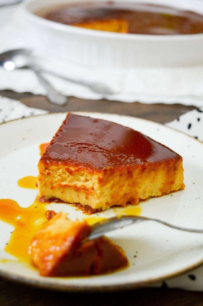 sliced pumpkin flan on a white plate