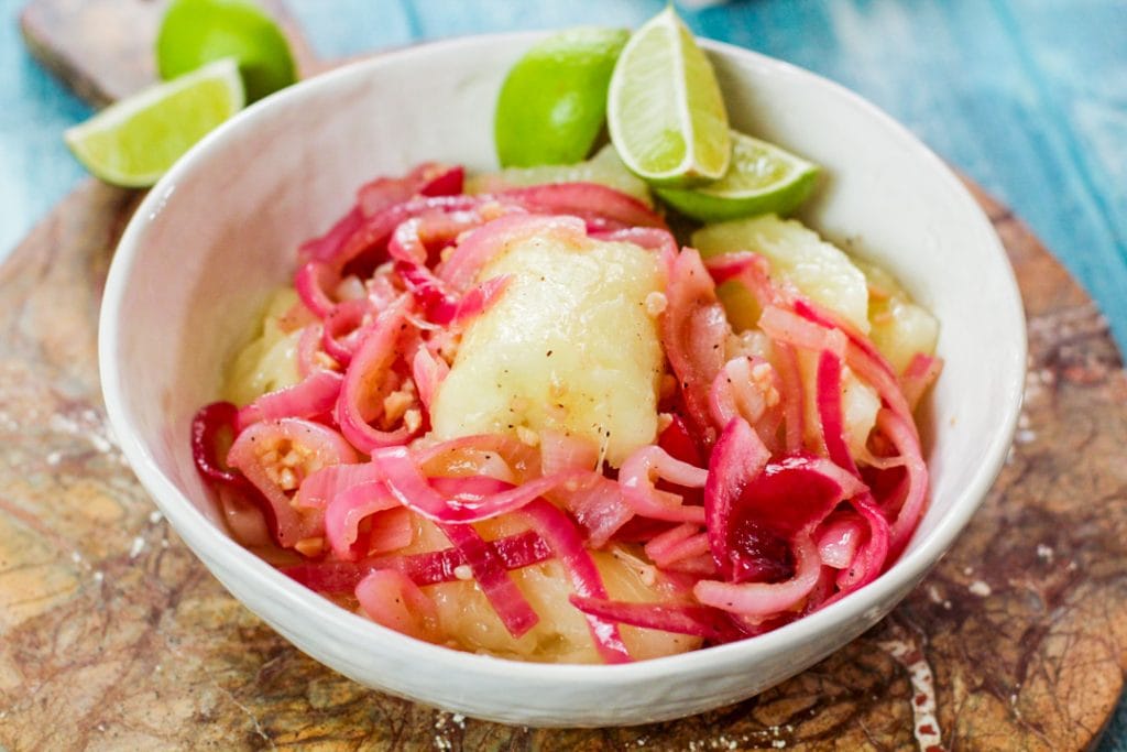 yuca con mojo in a white bowl