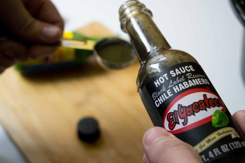 hot sauce being poured into a spoon