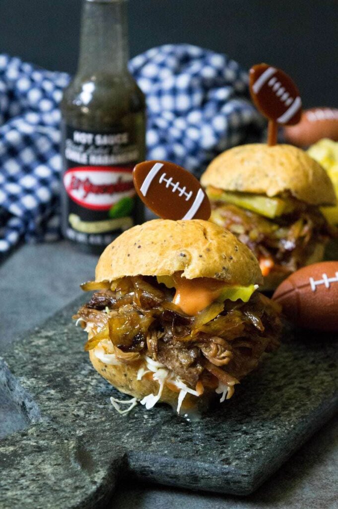 beef sliders in a bun on a marble platter