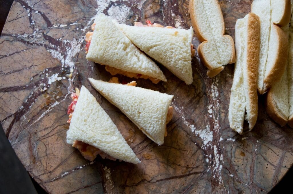 triangle sandwiches on a marble serving board