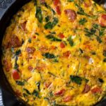 Cooked egg bake with colorful veggies and chorizo in a cast iron pan