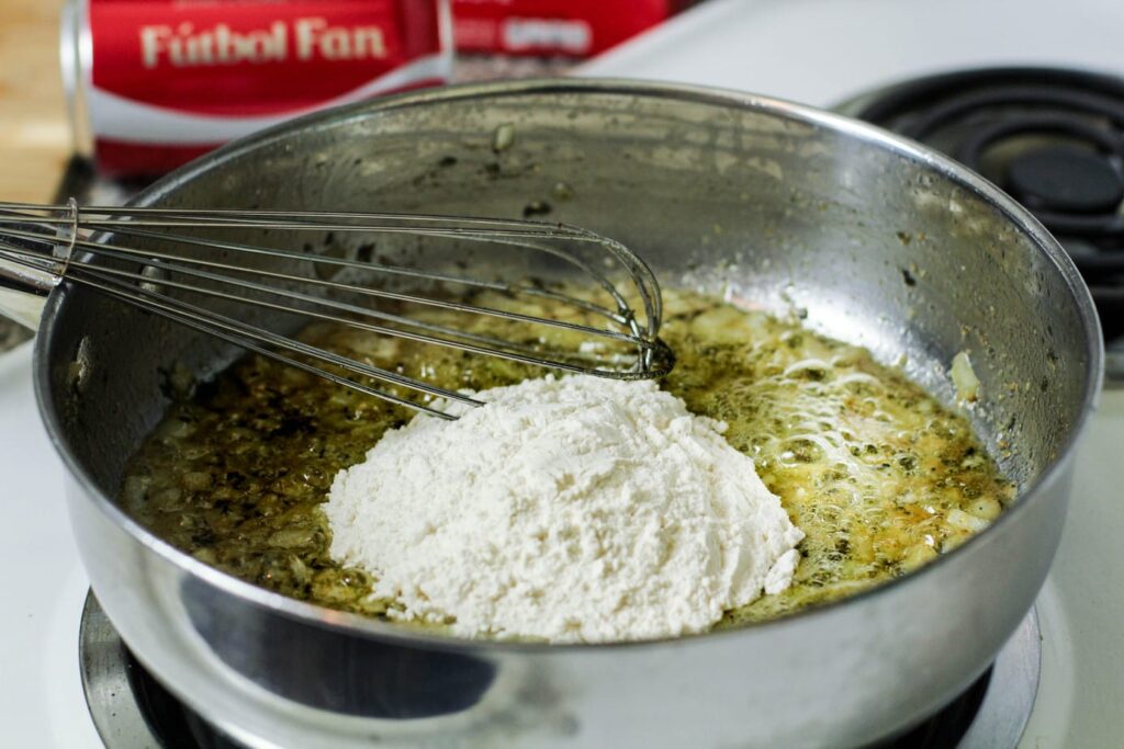 flour over a butter and herb mixture for croquettes