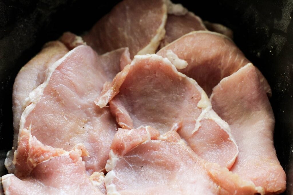 adobo seasoned pork chops in a slow cooker sleeve