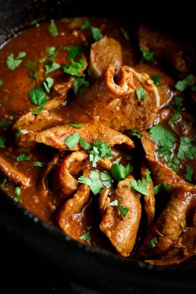 Chipotle pork chops sprinkled with chopped cilantro in the slow cooker