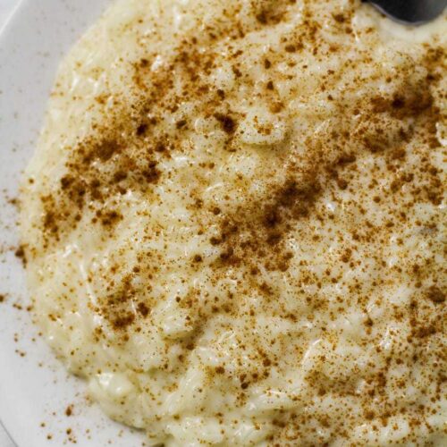 rice pudding with cinnamon on a white plate