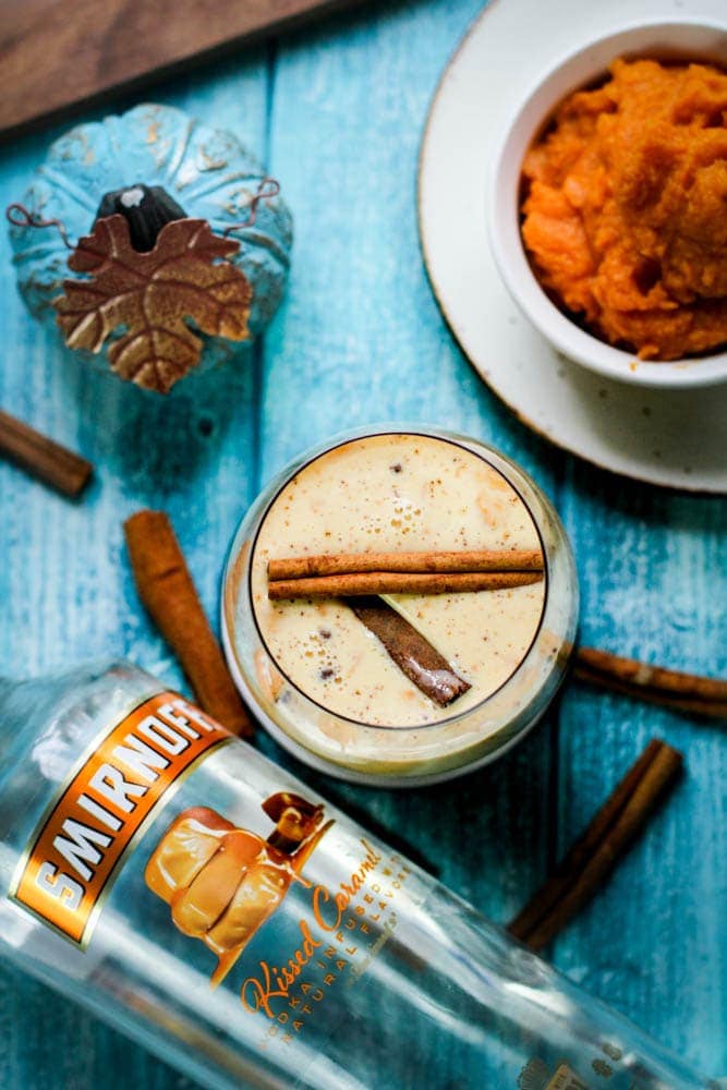 Coquito with vodka on a wooden blue background