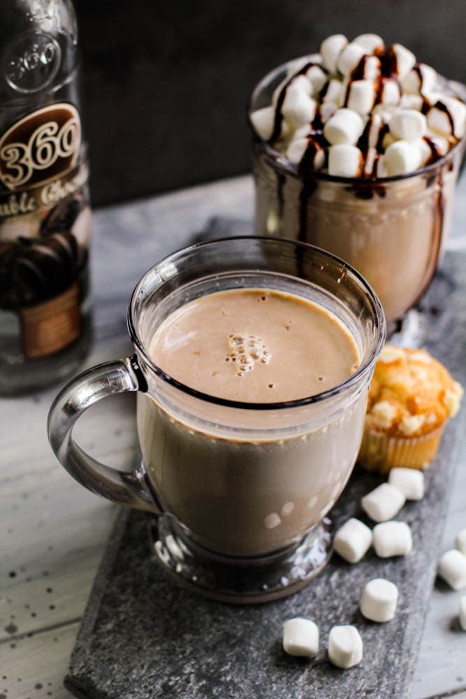 chocolate coquito in a glass cup on a serving tray