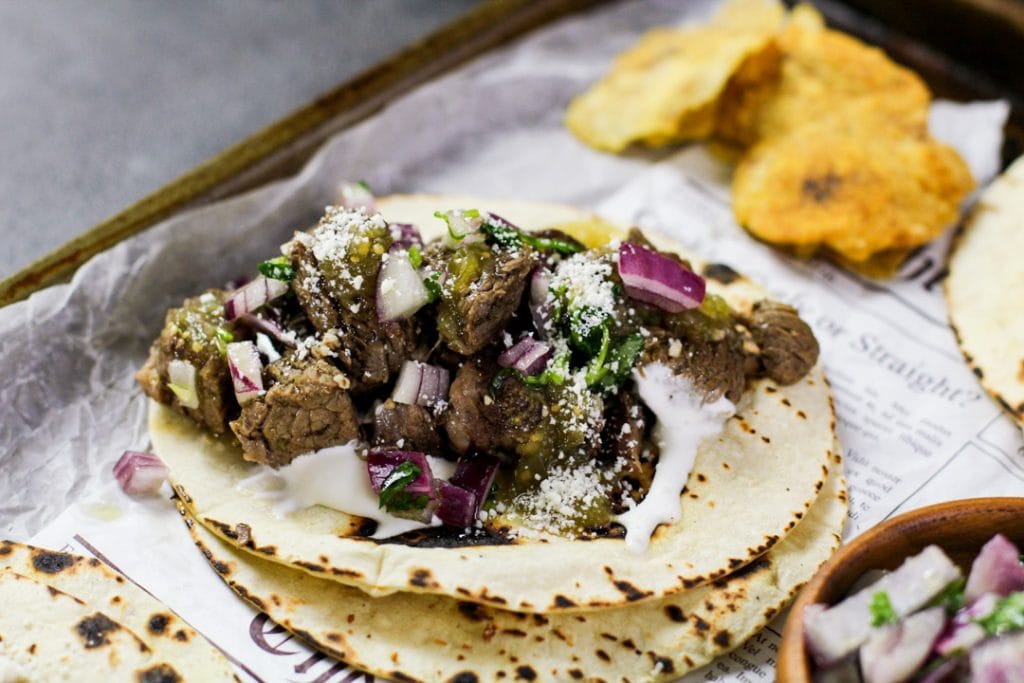 horizontal image of a steak taco on parchment paper