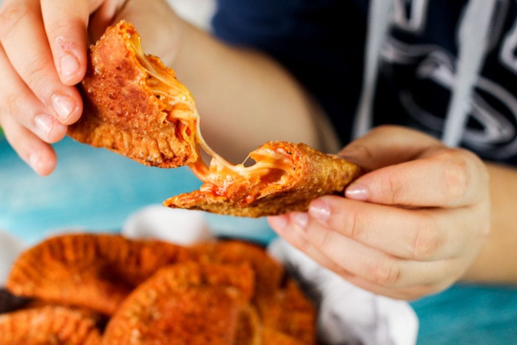 Stringy cheese in the center of a pizza empanada