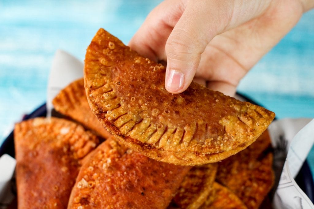 Empanada being held in a hand