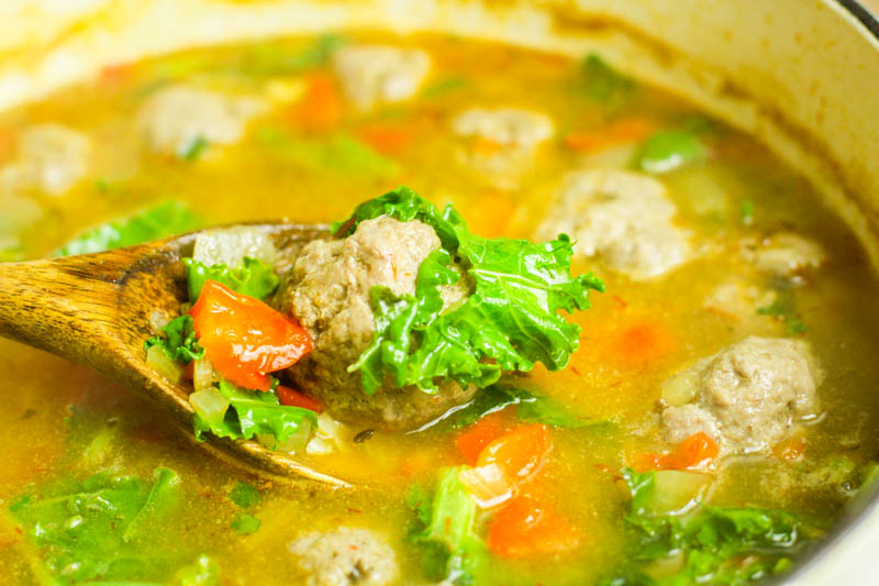 Kale and meatballs in a white pot