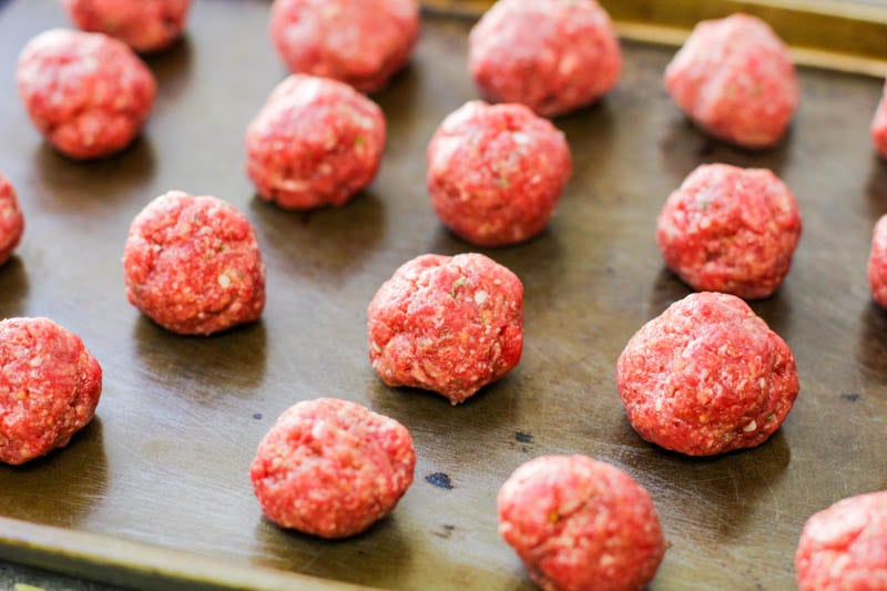 Raw albondigas on a baking pan