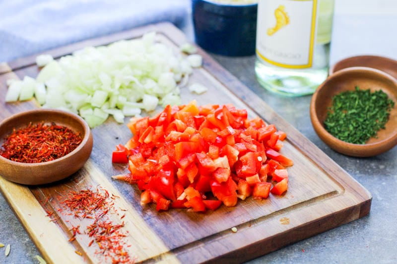 Chopped tomatoes and onions on a cutting board