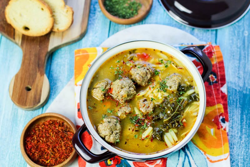 Saffron albondigas in a white pot