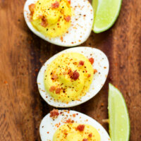 deviled eggs on a wooden serving board