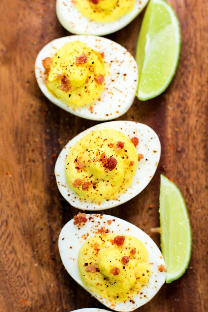 deviled eggs on a wooden serving board