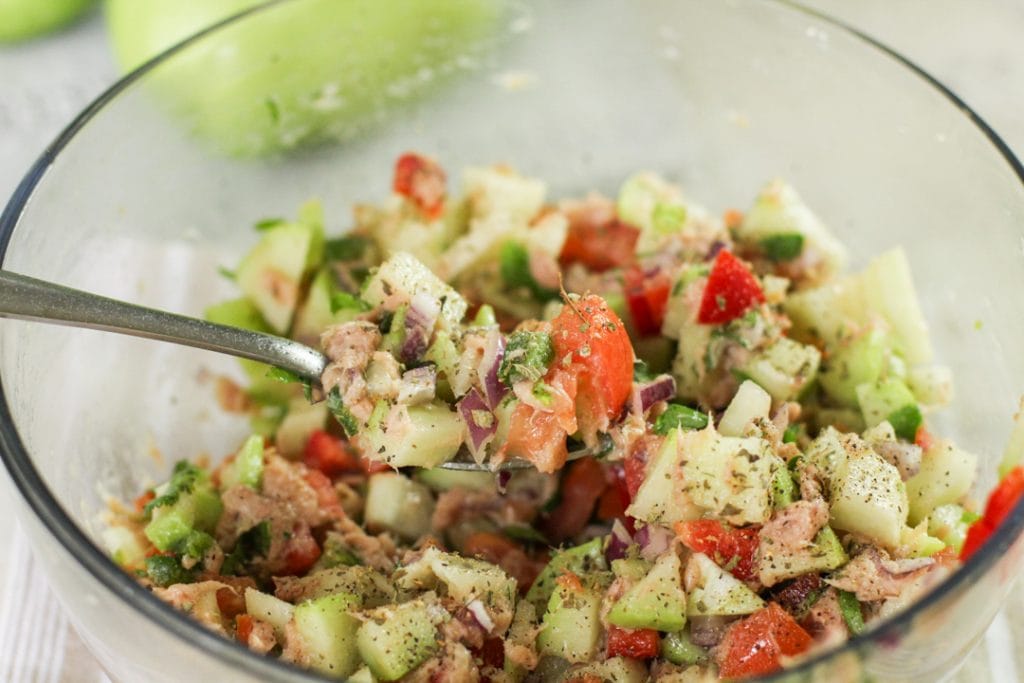 chayote tuna salad in a bowl with a spoon