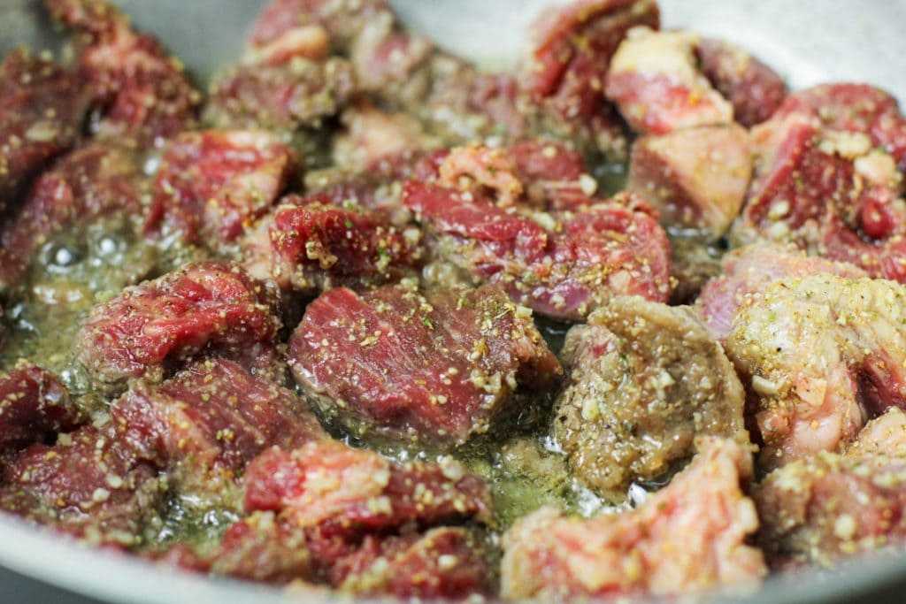 carne guisada getting cooked in a pan