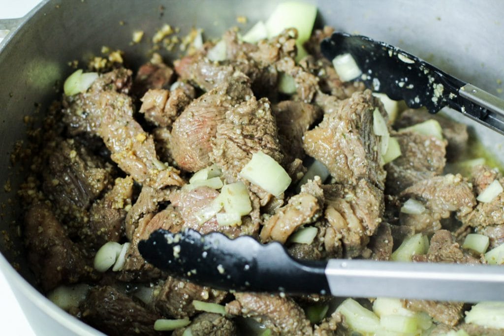 carne guisada with onions and wine