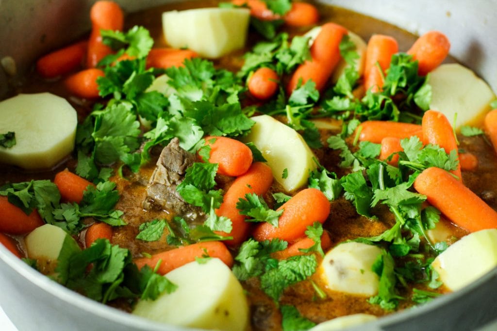 carne con papa and cilantro in a pot