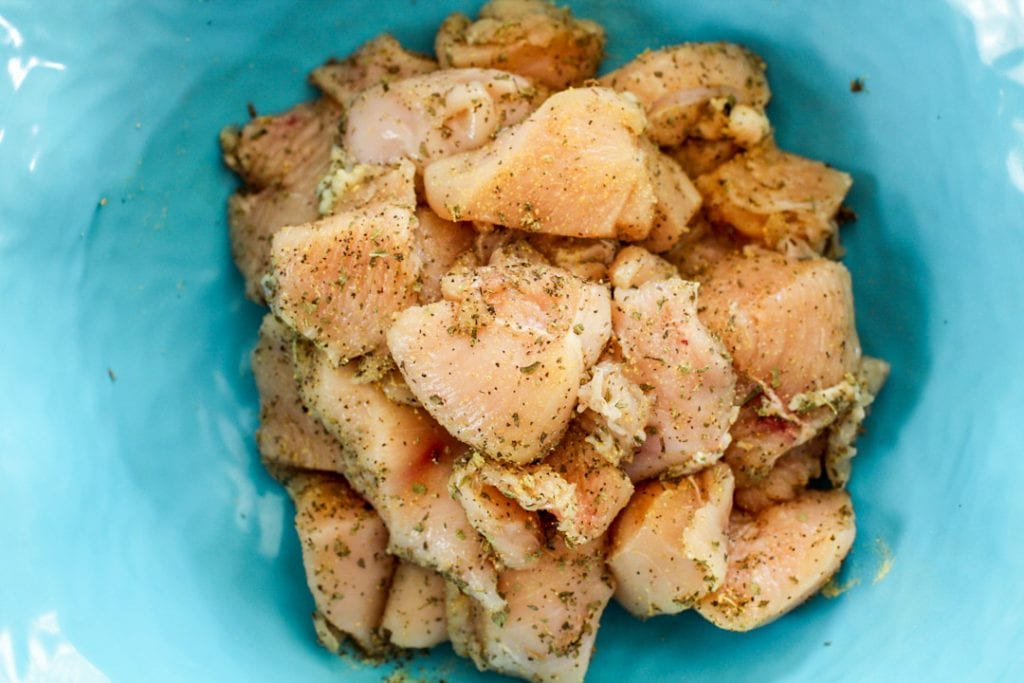 raw seasoned chicken in a bowl