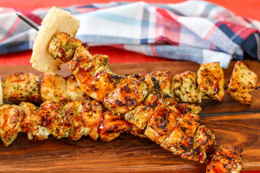 BBQ skewers on a wooden platter