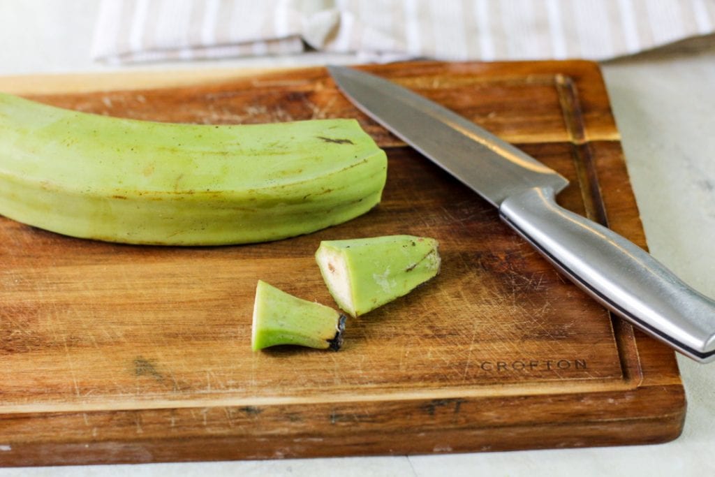 green plantain on a wooden cutting board