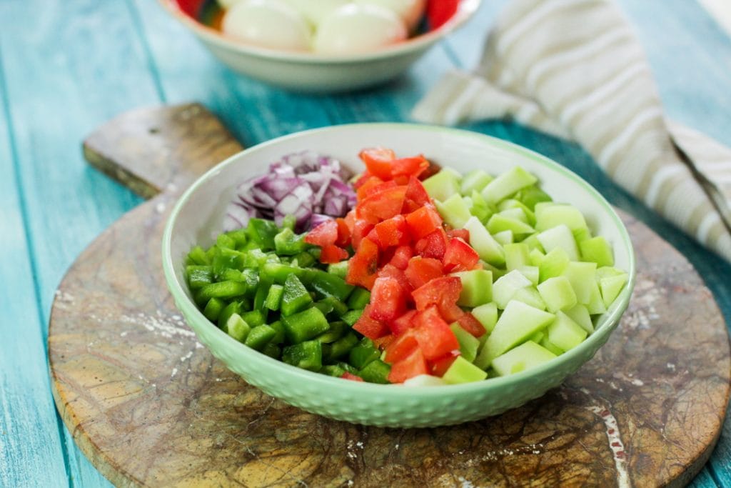 cut vegetables in a green bowl