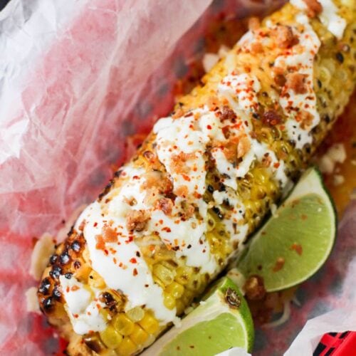 corn with sour cream and lime wedges