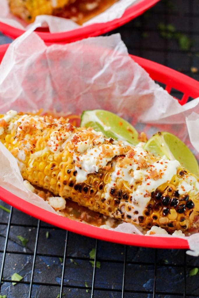 grilled street corn on a dark background