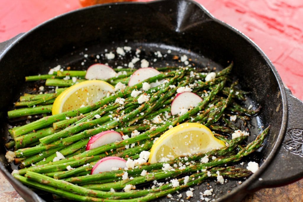 roasted asparagus with cheese and lemon wedges