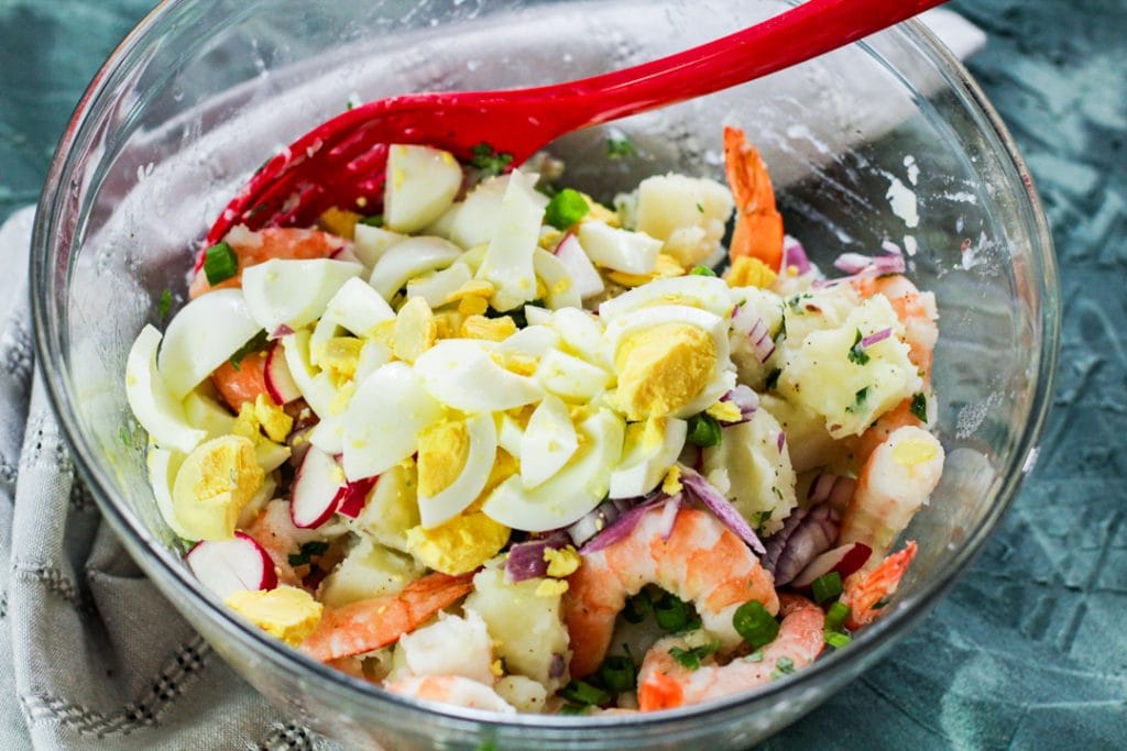 shrimp potato salad with eggs in bowl