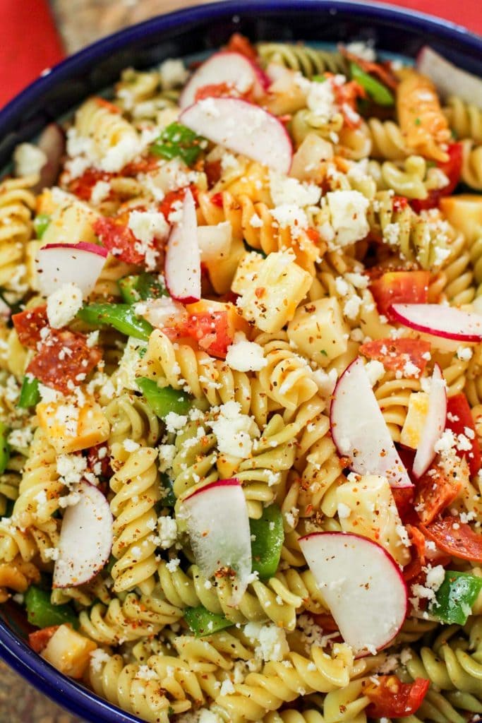 pasta, radishes, and crumbled cheese in a bowl