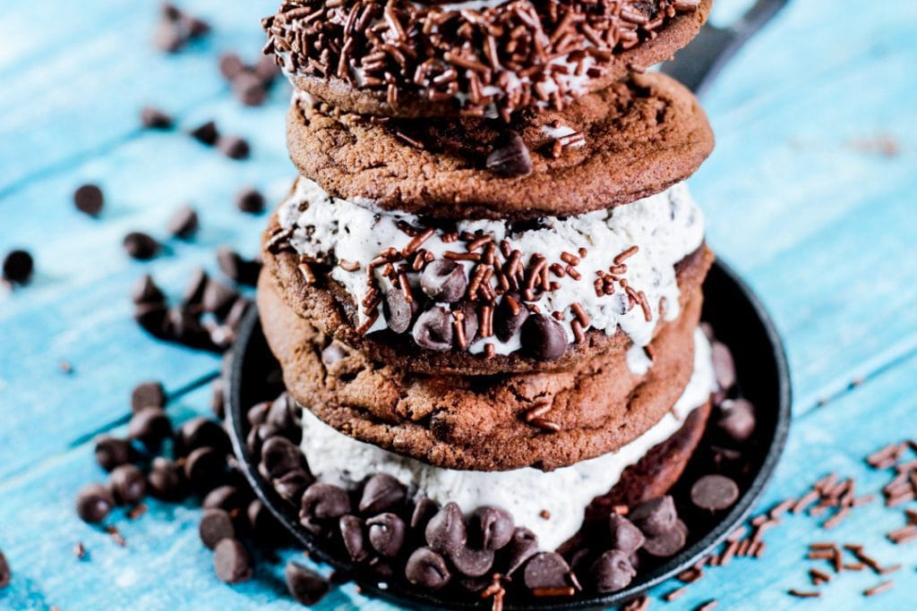 chocolate chips and chocolate sprinkles surrounding ice cream sandwiches