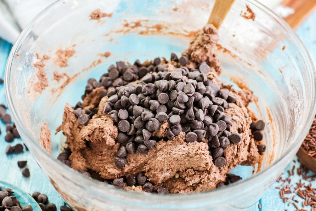 chocolate chips with cookie dough in a glass bowl