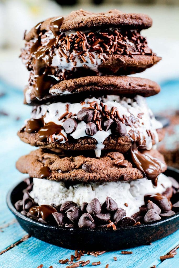 double chocolate chip ice cream cookie towers with a blue wooden background