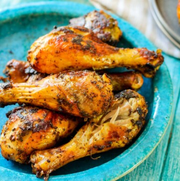 roasted drumsticks on a blue plate