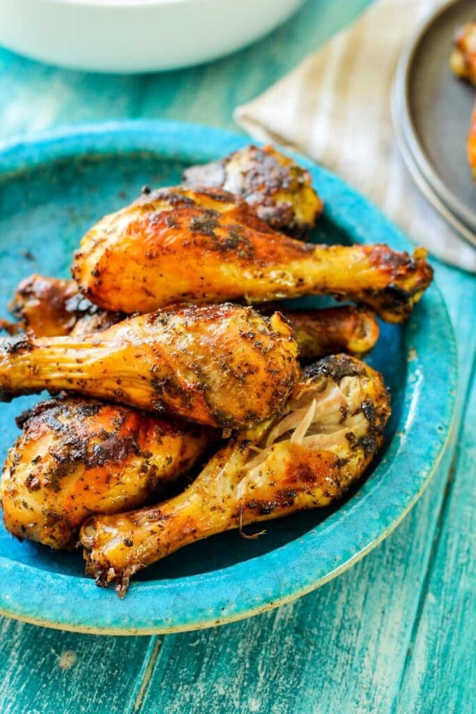 roasted drumsticks on a blue plate