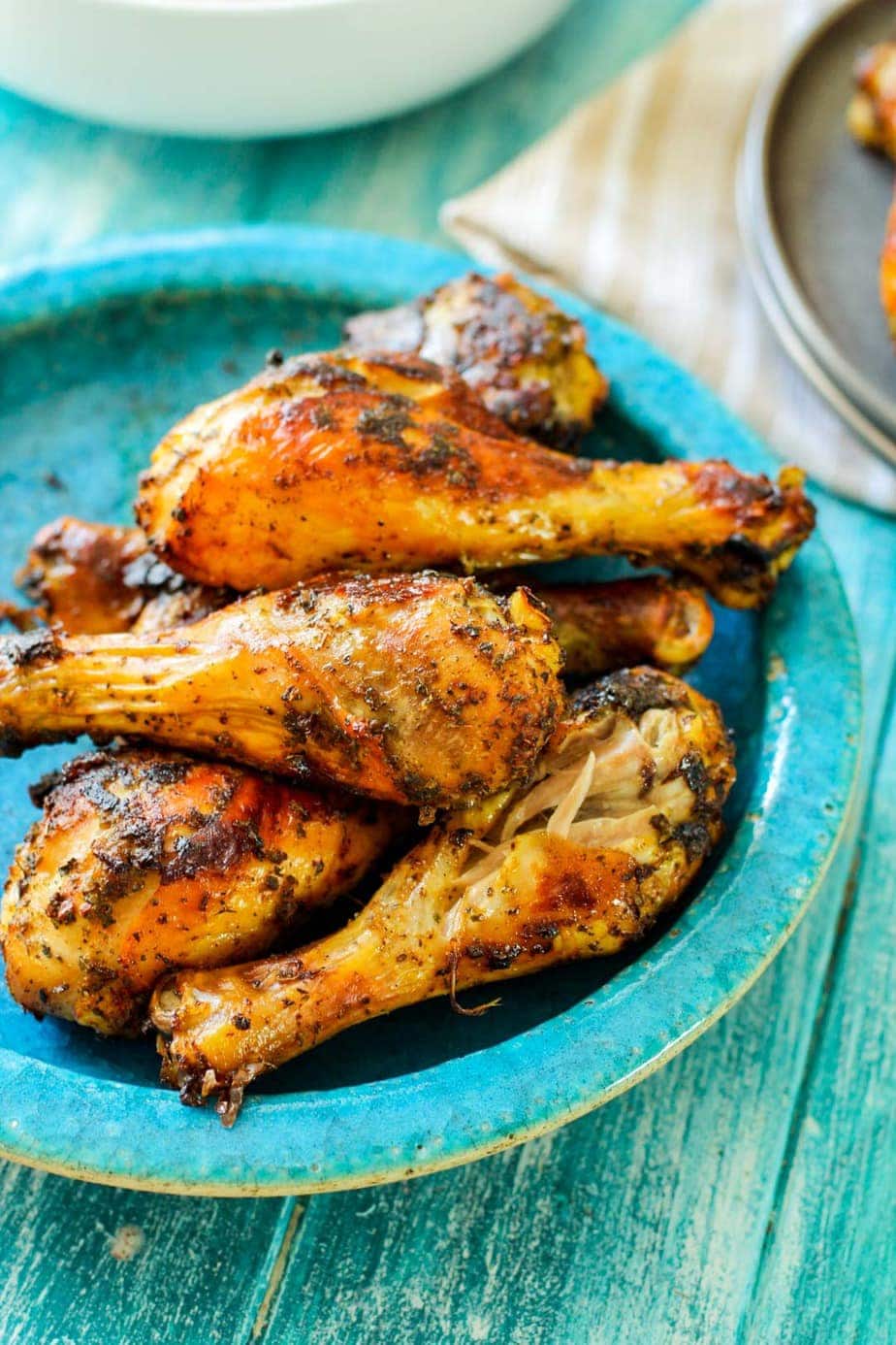 roasted drumsticks on a blue plate