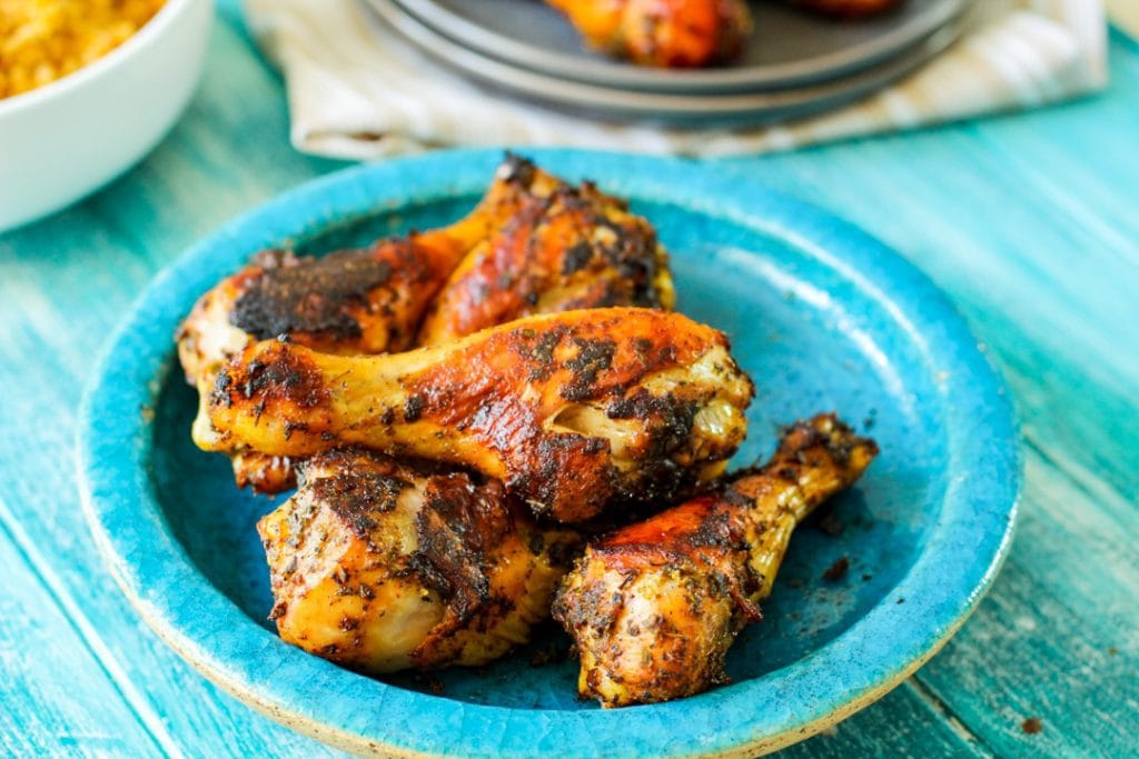 roasted chicken on a blue plate with a blue background