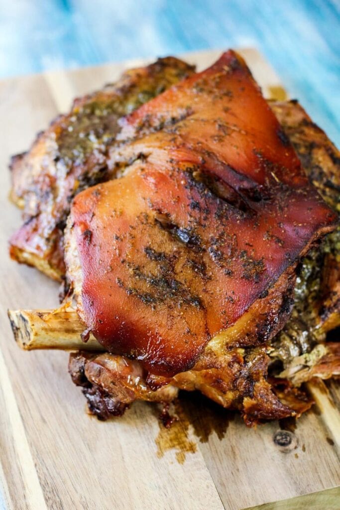 whole roasted Adobo pork on a cutting board