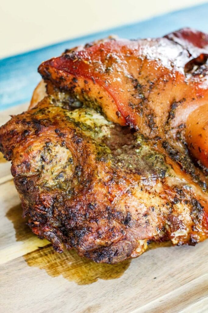 close up of cooked pernil on a cutting board