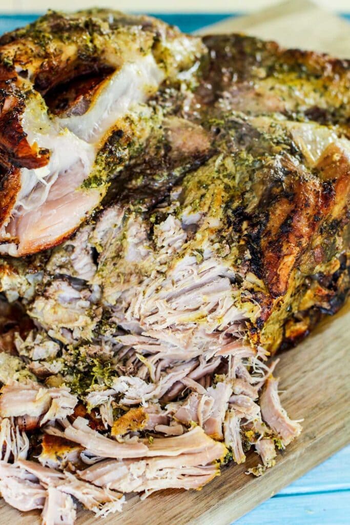 shredded pernil on a cutting board