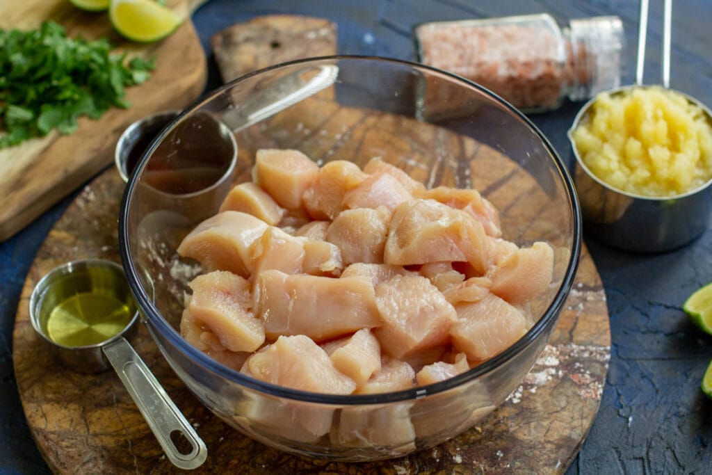 raw cut chicken in a glass bowl