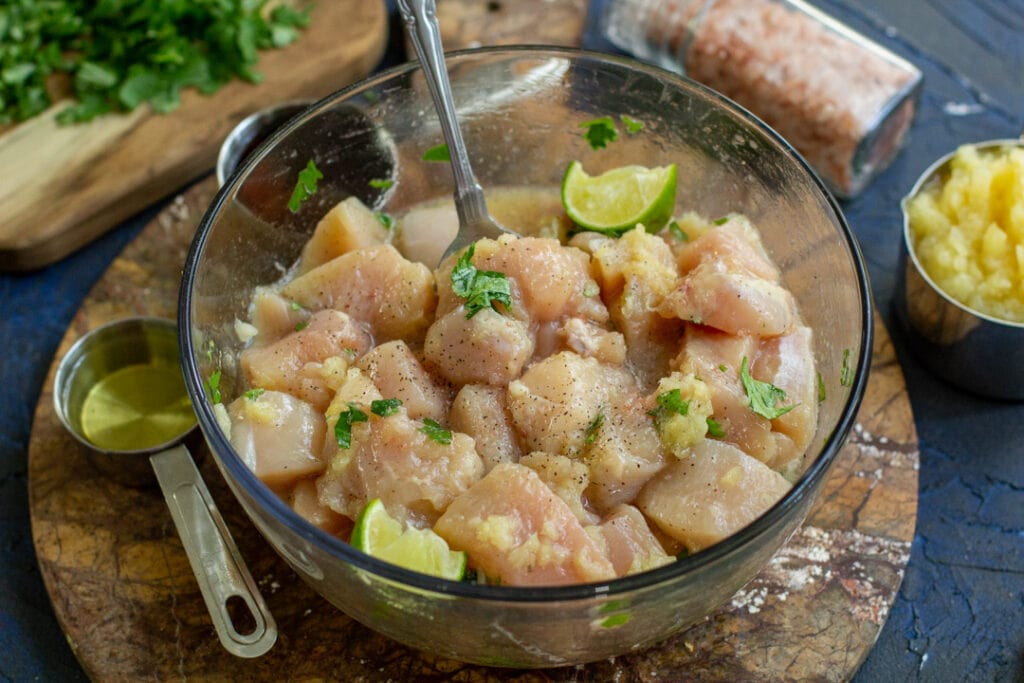 marinated raw chicken in a glass bowl