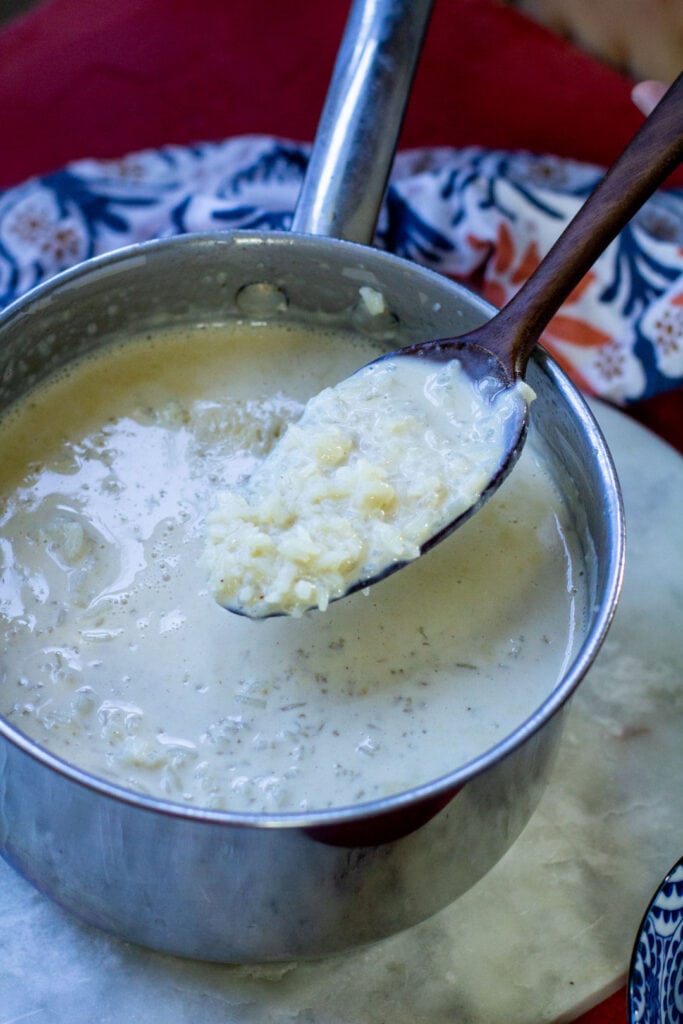 rice with milk on a wooden spoon