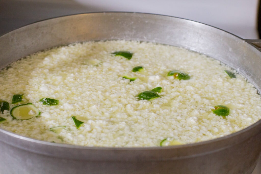 curdled milk floating to the top of a pot