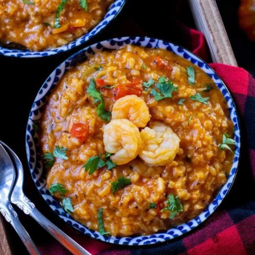 rice and shrimp stew in a blue plate