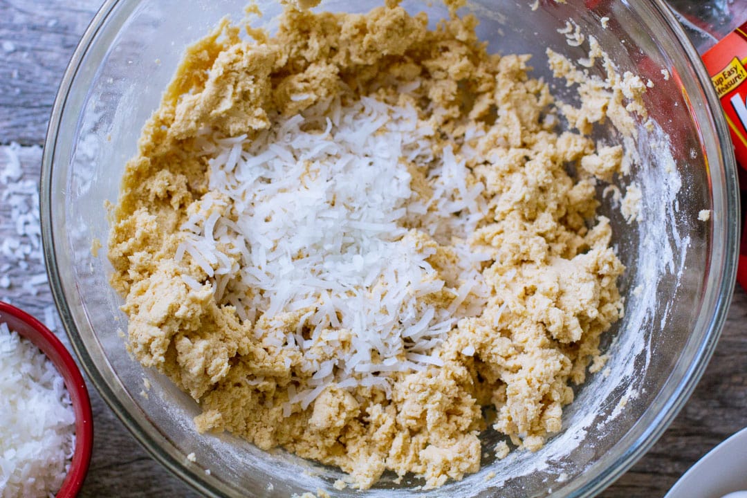 Shredded coconut flakes over raw cookie dough